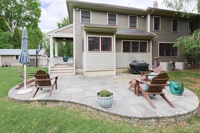 5 Baxter St, Westborough, MA 01581 - rear view of house featuring a yard, central AC unit, and a patio