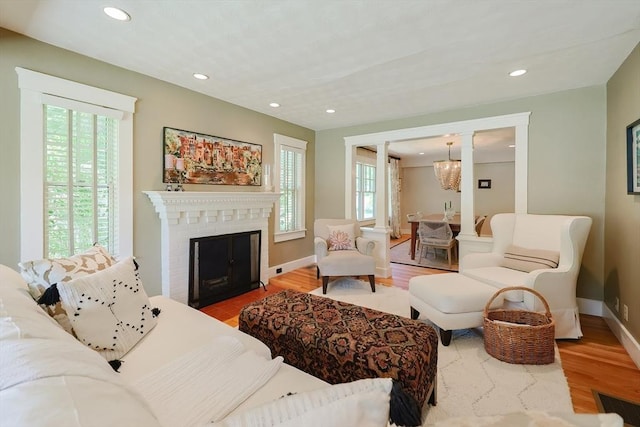 5 Baxter St, Westborough, MA 01581 - living room featuring wood finished floors, a fireplace, baseboards, recessed lighting, and a chandelier