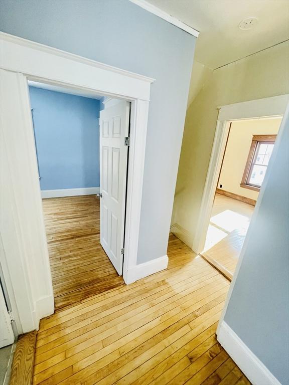 corridor with light hardwood / wood-style floors