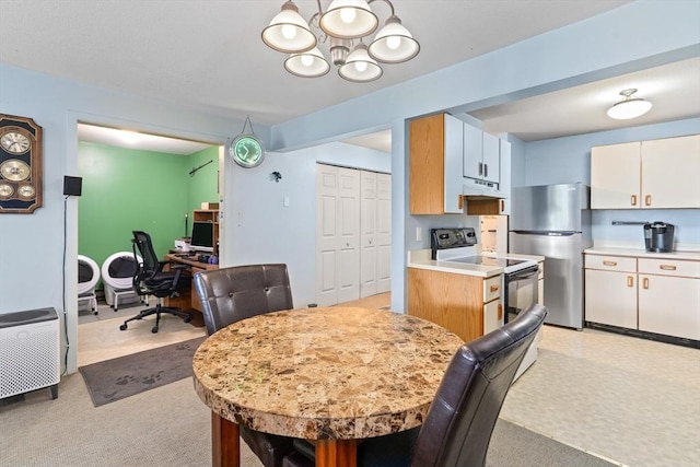 23 Randolph Pl Unit 301, Northampton, MA 01060 - kitchen with range with electric stovetop, freestanding refrigerator, under cabinet range hood, a chandelier, and light countertops