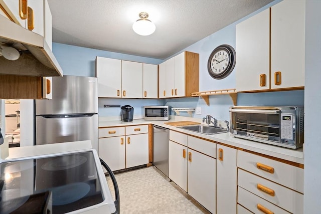 23 Randolph Pl Unit 301, Northampton, MA 01060 - kitchen featuring stainless steel appliances, light countertops, light floors, and white cabinetry