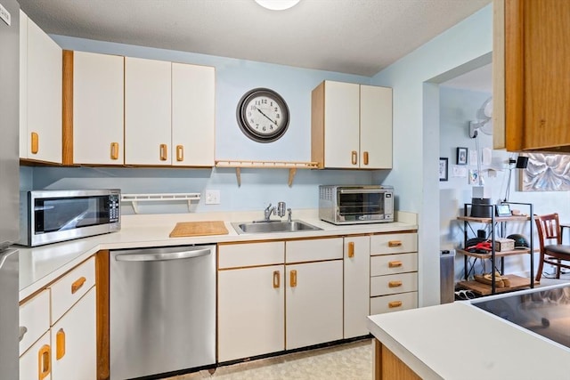 23 Randolph Pl Unit 301, Northampton, MA 01060 - kitchen with stainless steel appliances, a sink, light countertops, and white cabinets