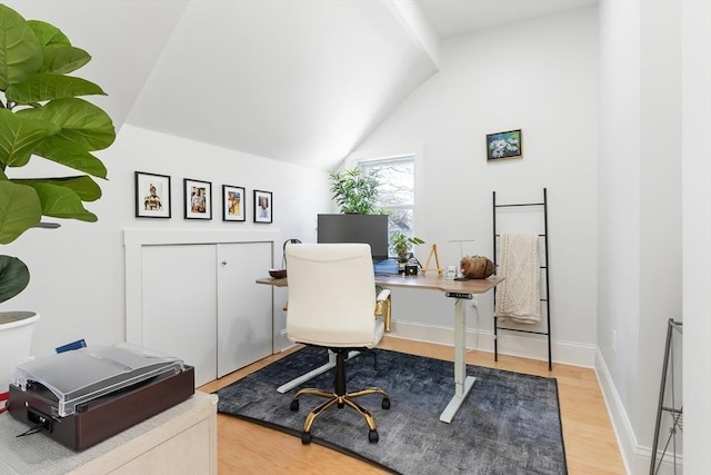 office space featuring wood-type flooring and vaulted ceiling