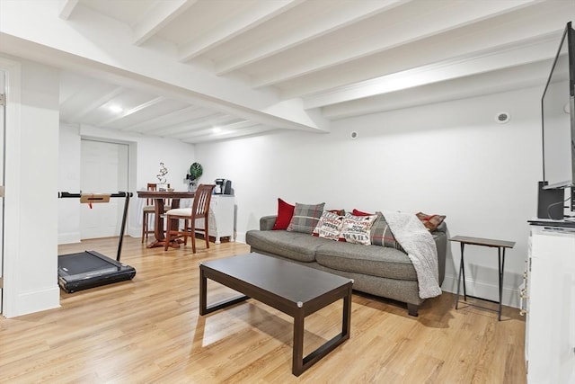 living room with beam ceiling and light hardwood / wood-style floors