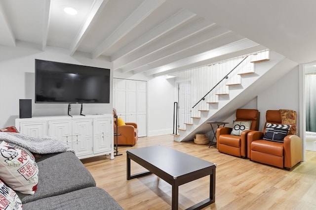 living room featuring beam ceiling and light wood-type flooring