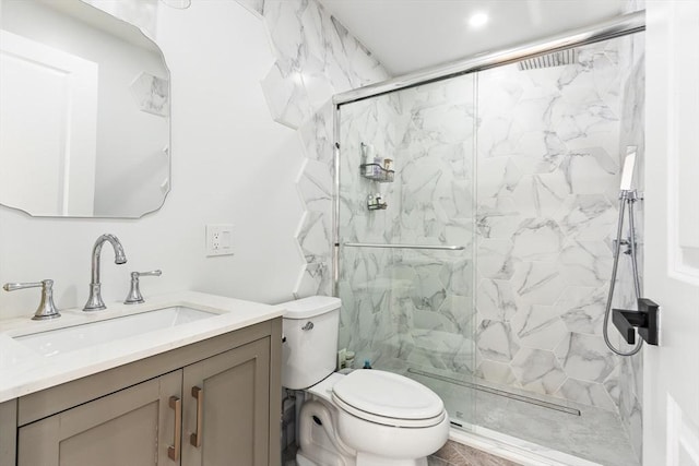 bathroom featuring vanity, toilet, and a shower with door