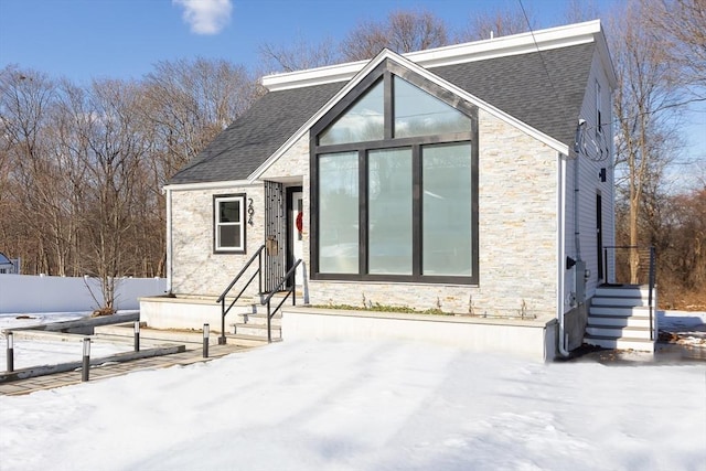 view of snow covered back of property