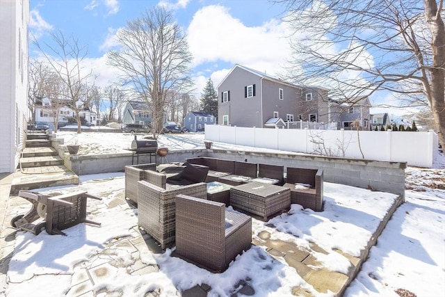 snow covered patio with area for grilling