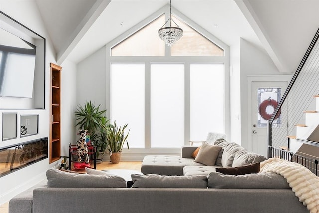 living room featuring a notable chandelier and vaulted ceiling