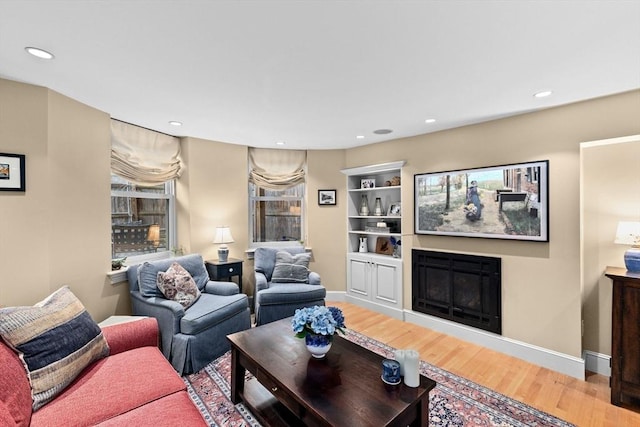 12 Braddock Park Unit 1, Boston, MA 02116 - living room with wood finished floors, a glass covered fireplace, baseboards, and recessed lighting