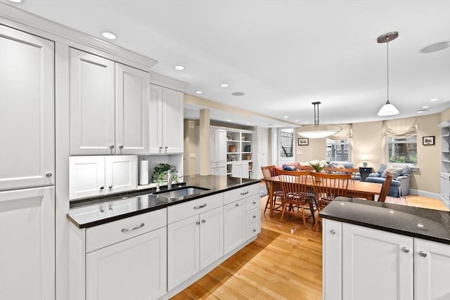 12 Braddock Park Unit 1, Boston, MA 02116 - kitchen featuring a sink, light wood-style floors, white cabinets, recessed lighting, and open floor plan