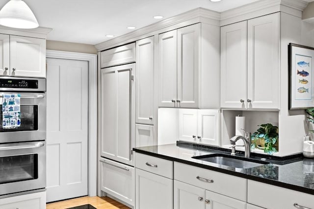 12 Braddock Park Unit 1, Boston, MA 02116 - kitchen with double oven, a sink, recessed lighting, white cabinets, and dark stone counters