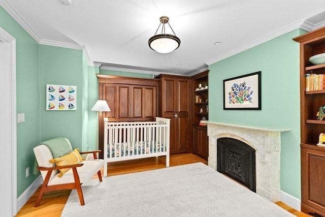 12 Braddock Park Unit 1, Boston, MA 02116 - bedroom with light wood finished floors, crown molding, a premium fireplace, and baseboards