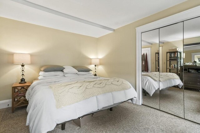 bedroom featuring a closet, baseboards, and carpet flooring