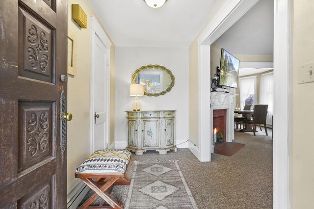 hall featuring carpet floors and baseboards