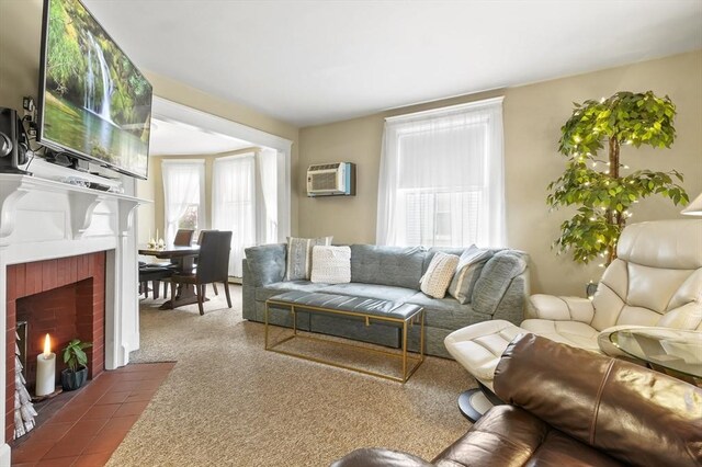 living room featuring a fireplace and an AC wall unit