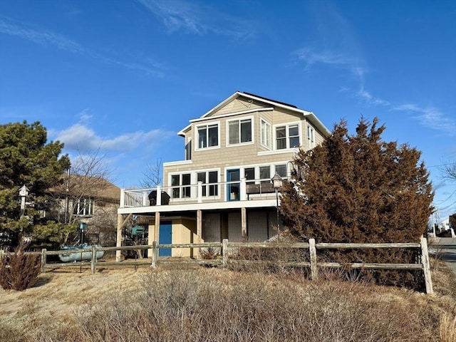 back of property with fence and a deck