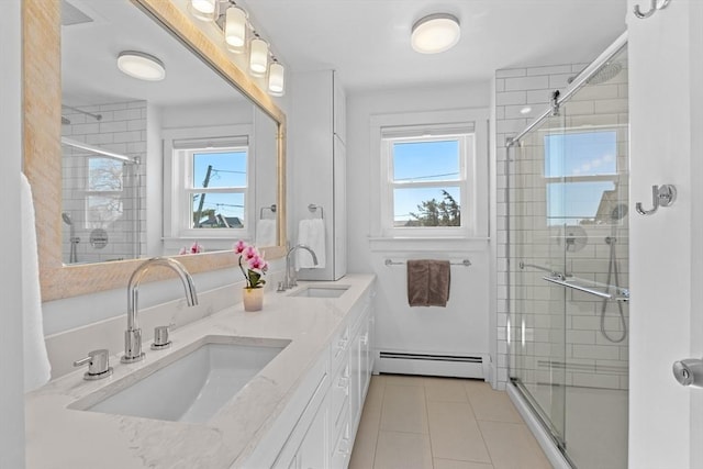 full bath featuring a baseboard heating unit, double vanity, a stall shower, and a sink