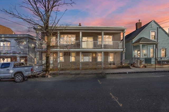 view of front of home featuring a balcony