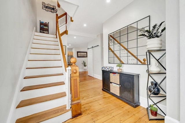 59 Bonair St, Somerville, MA 02145 - stairway featuring a barn door, hardwood / wood-style flooring, recessed lighting, and baseboards
