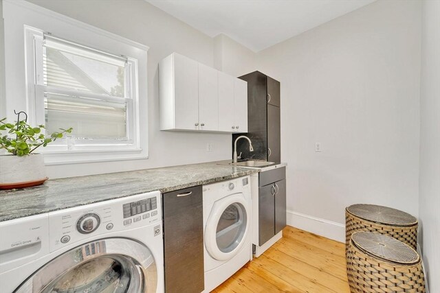 59 Bonair St, Somerville, MA 02145 - laundry room with independent washer and dryer, light wood finished floors, cabinet space, and baseboards
