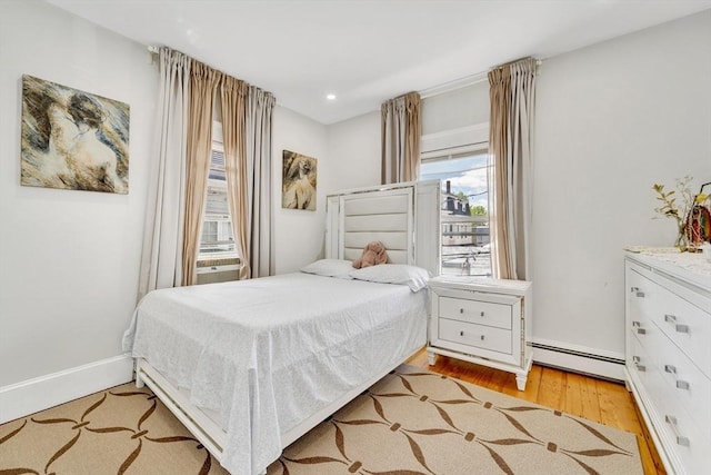 59 Bonair St, Somerville, MA 02145 - bedroom featuring baseboard heating, wood finished floors, recessed lighting, and baseboards
