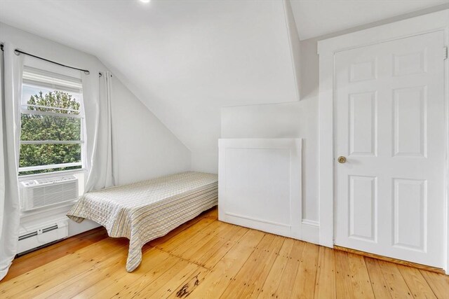 59 Bonair St, Somerville, MA 02145 - bedroom featuring lofted ceiling, a baseboard radiator, hardwood / wood-style flooring, and cooling unit