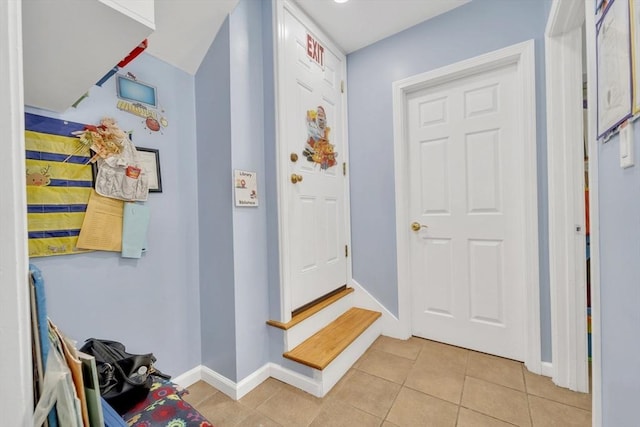 59 Bonair St, Somerville, MA 02145 - entrance foyer featuring light tile patterned floors, baseboards, and stairs