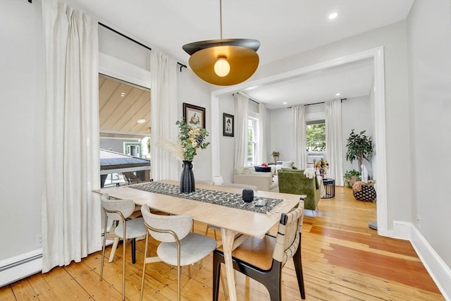 59 Bonair St, Somerville, MA 02145 - dining space featuring a baseboard heating unit, light wood-style floors, and baseboards