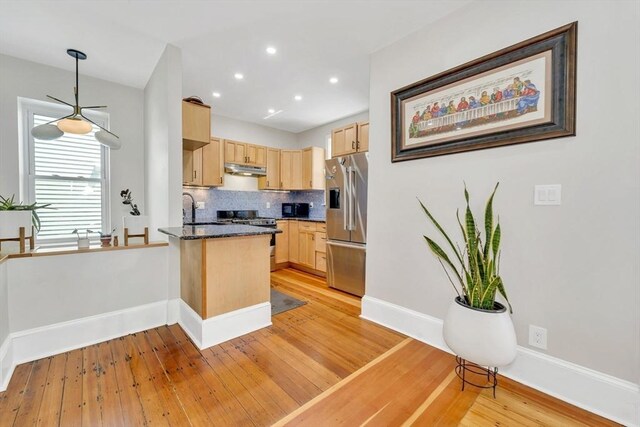 59 Bonair St, Somerville, MA 02145 - kitchen with light brown cabinets, stainless steel appliances, a peninsula, decorative backsplash, and light wood-style floors