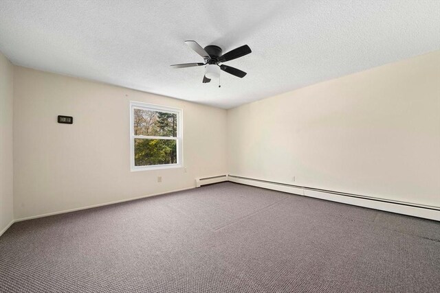 carpeted empty room with a ceiling fan, baseboards, baseboard heating, and a textured ceiling