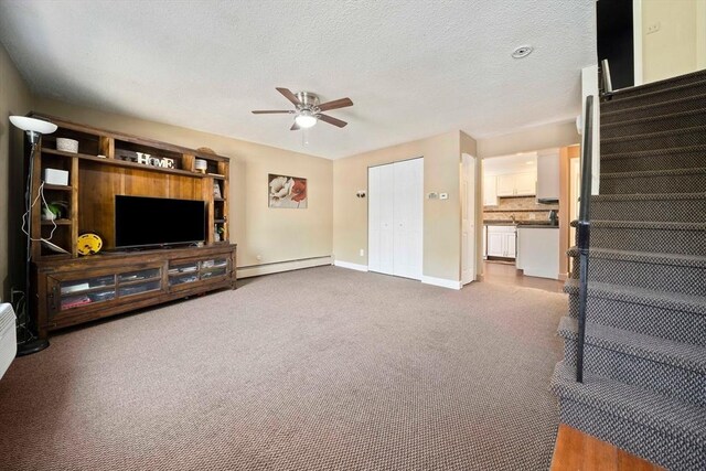 unfurnished living room with stairs, dark colored carpet, baseboards, ceiling fan, and a baseboard radiator