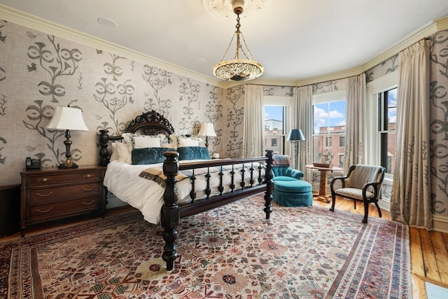 bedroom featuring ornamental molding and hardwood / wood-style floors