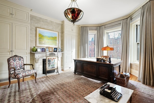 sitting room featuring light wood-type flooring and crown molding