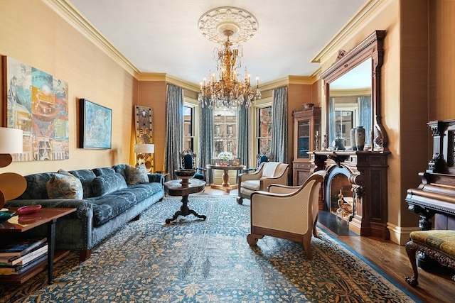 living area with ornamental molding, hardwood / wood-style flooring, and a chandelier