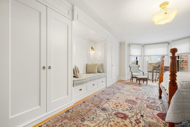 interior space featuring ornamental molding and light hardwood / wood-style floors