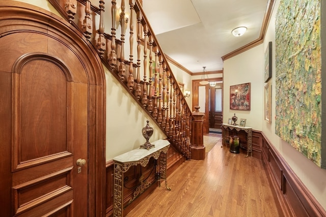 interior space with light hardwood / wood-style flooring and ornamental molding