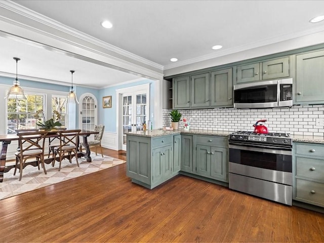 kitchen featuring a peninsula, dark wood-style flooring, appliances with stainless steel finishes, french doors, and light stone countertops