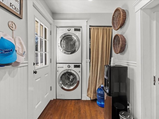 laundry area with laundry area, stacked washing maching and dryer, and dark wood finished floors