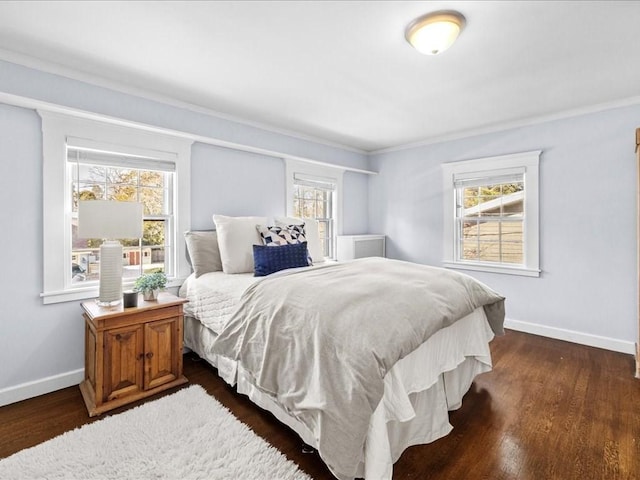 bedroom with dark wood-style flooring and baseboards