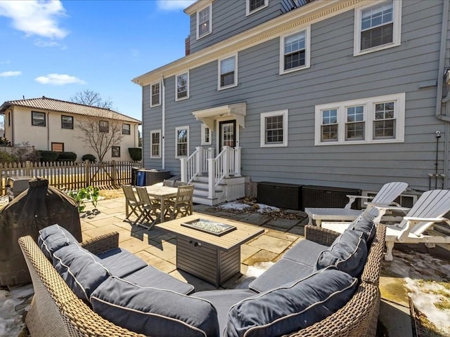 view of patio / terrace featuring outdoor dining area, an outdoor living space with a fire pit, and fence