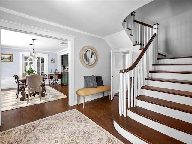 entrance foyer featuring stairs, visible vents, crown molding, and wood finished floors