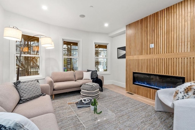20 Boylston St Unit 3, Boston, MA 02130 - living room with a glass covered fireplace, wood finished floors, baseboards, and recessed lighting