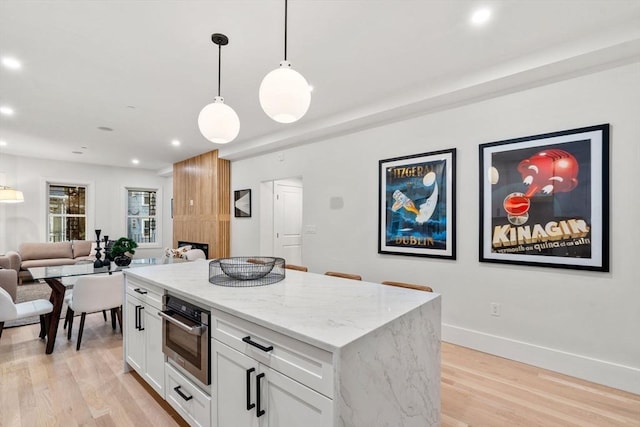20 Boylston St Unit 3, Boston, MA 02130 - kitchen with open floor plan, white cabinets, hanging light fixtures, light wood-style floors, and recessed lighting
