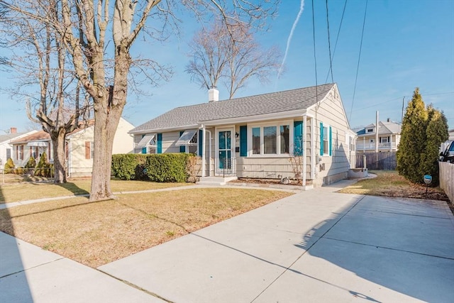 bungalow-style home with a front lawn