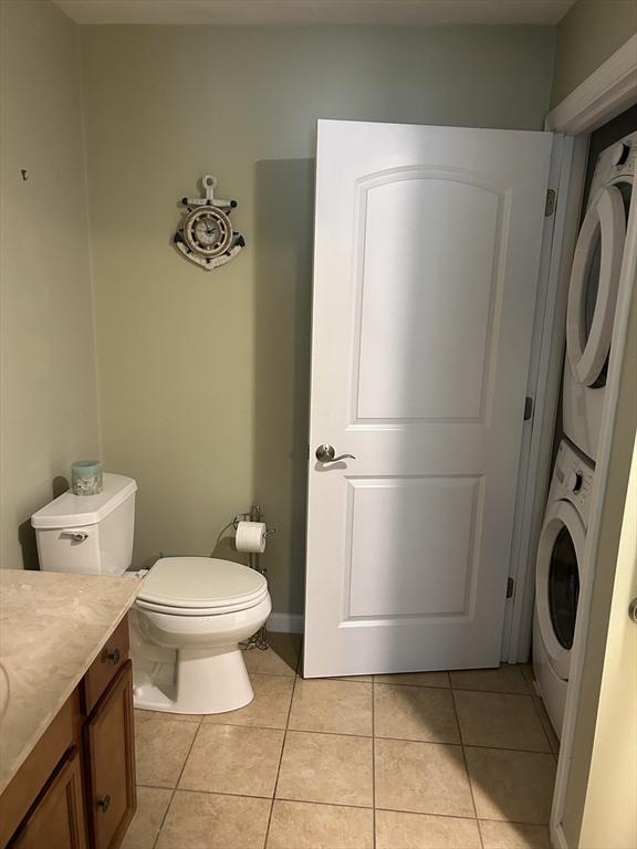 1 Hayloft Ln Unit 1, Marshfield, MA 02050 - half bathroom with stacked washer / dryer, tile patterned floors, and vanity