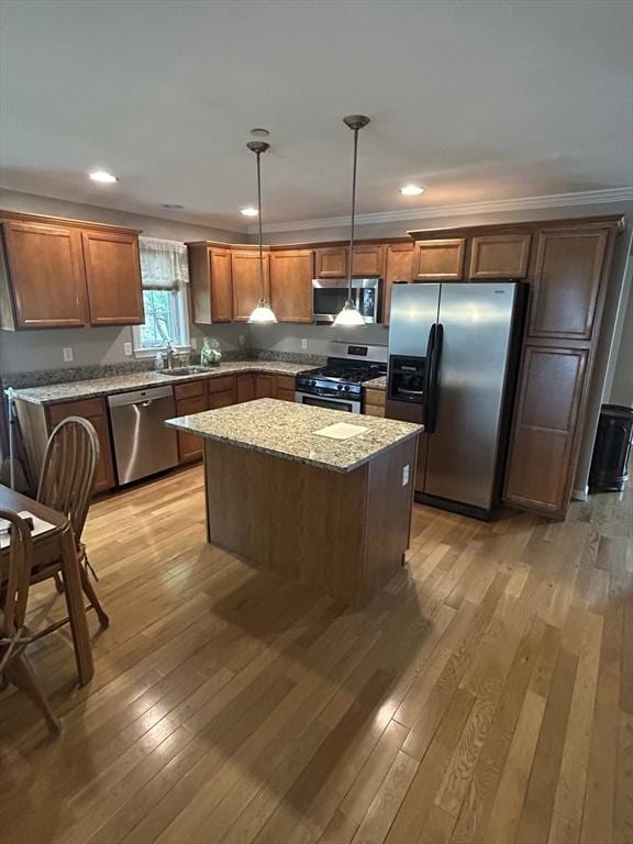 1 Hayloft Ln Unit 1, Marshfield, MA 02050 - kitchen with stainless steel appliances, light wood-style flooring, a kitchen island, light stone countertops, and recessed lighting