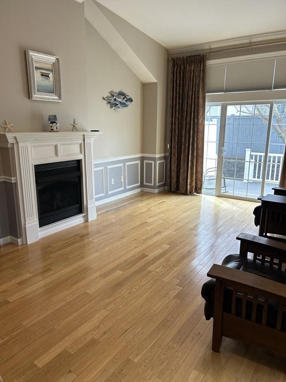 1 Hayloft Ln Unit 1, Marshfield, MA 02050 - living room featuring light wood-style flooring, a fireplace, a decorative wall, and wainscoting