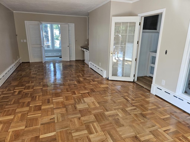 entryway with crown molding and a baseboard heating unit