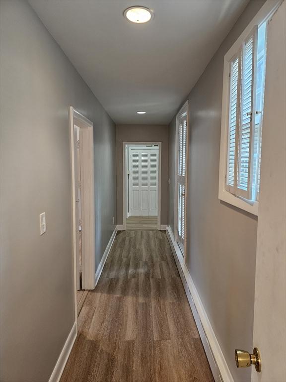 hall with wood finished floors and baseboards